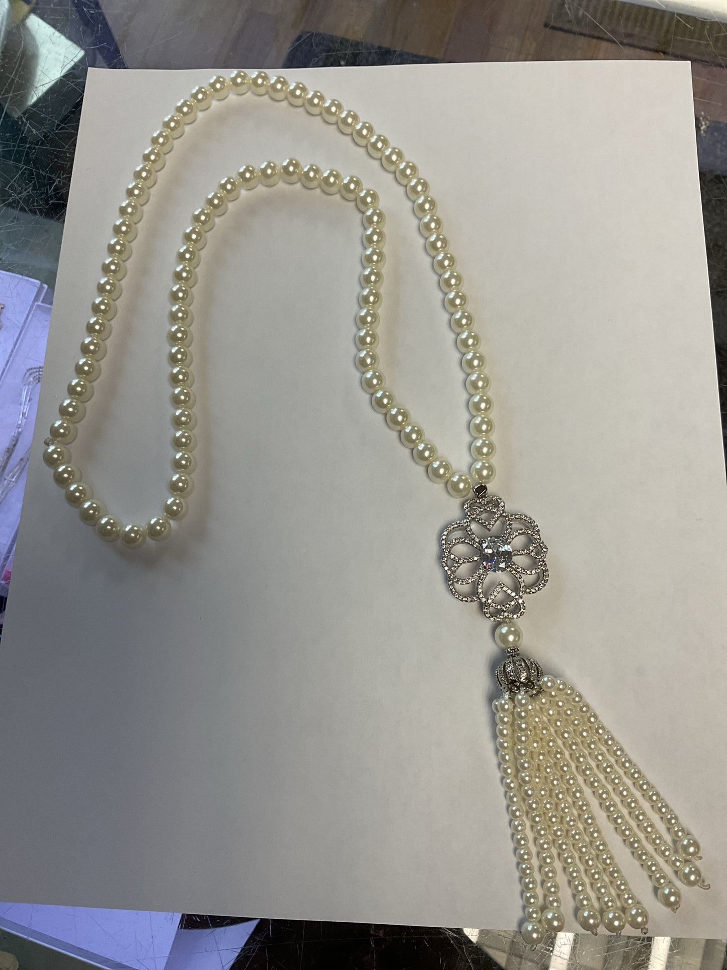 Necklace long pearl strand with tassels and silver cz decor