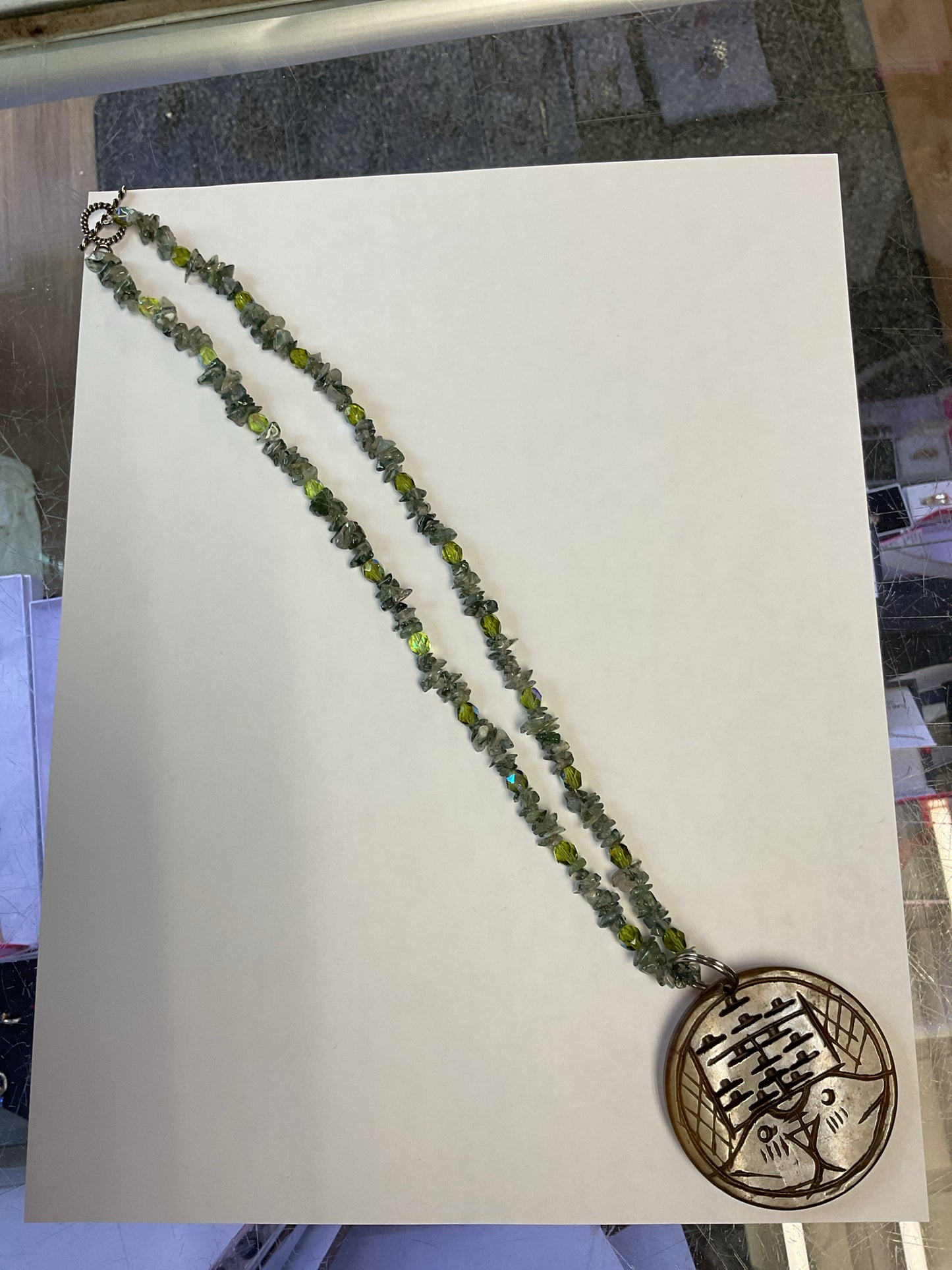 Necklace blue green stones with large round bird pendant