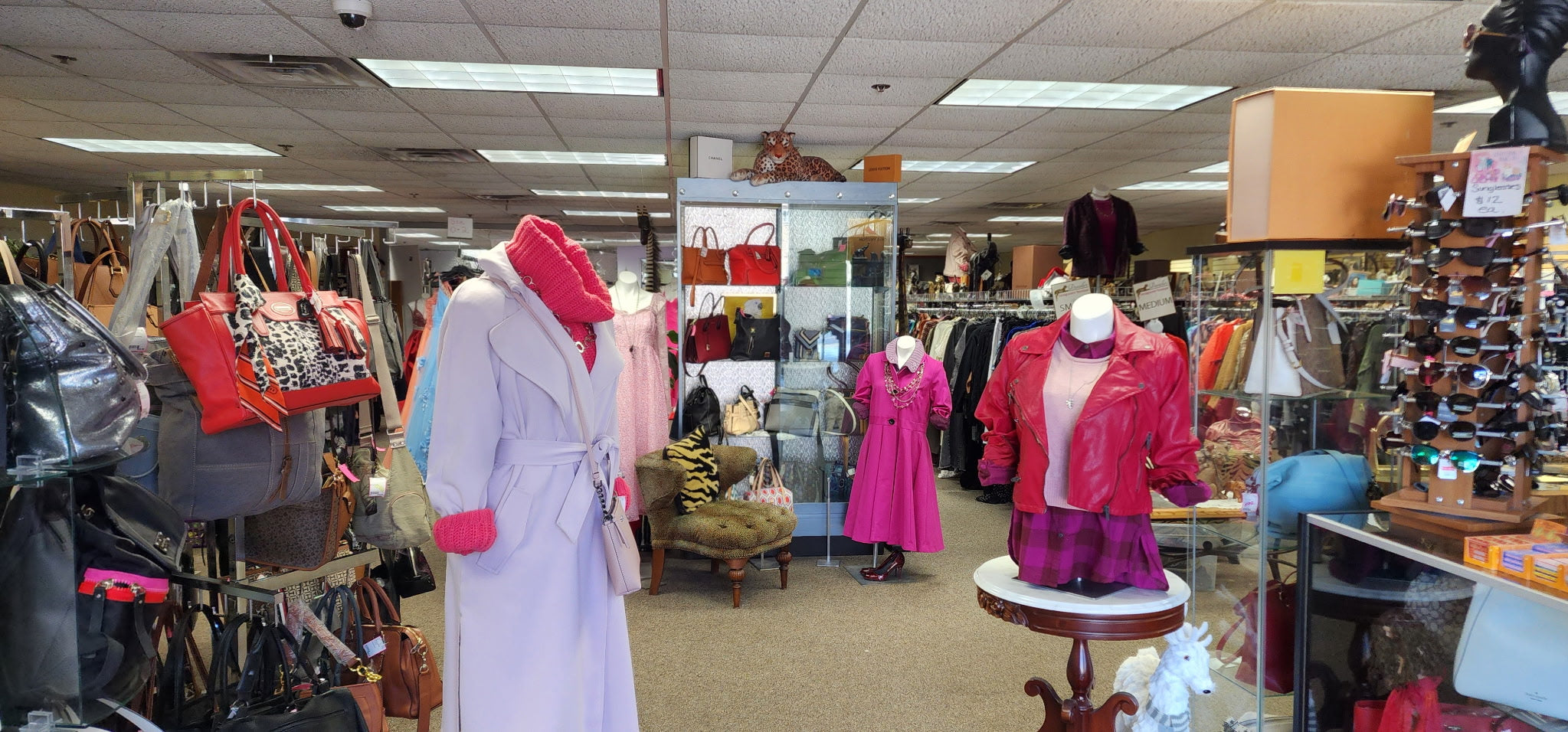 Trendy women's fashion, including jackets, dresses, and accessories, displayed on mannequins at Danielle’s Consignment Boutique.